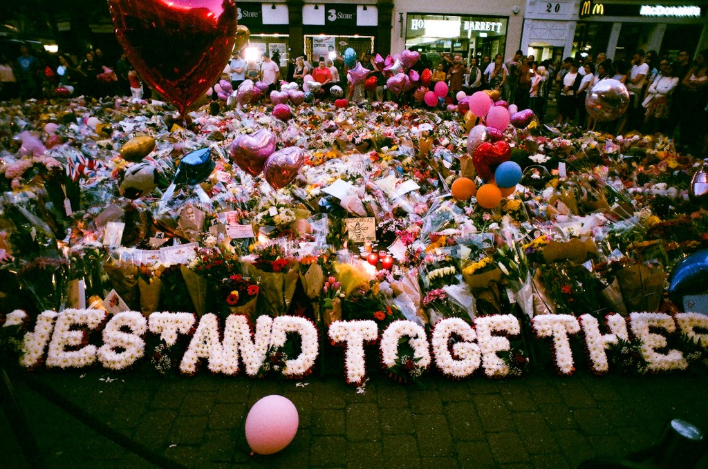 A colour image of floral tributes in St Ann's Square, Manchester.