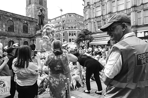 A black and white image of a Response Pastor in St Ann's Square, Manchester.