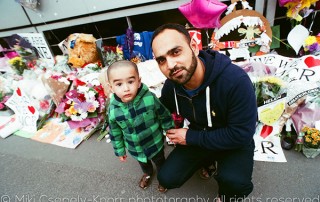 A colour image of a father and son in St Ann's Square, Manchester